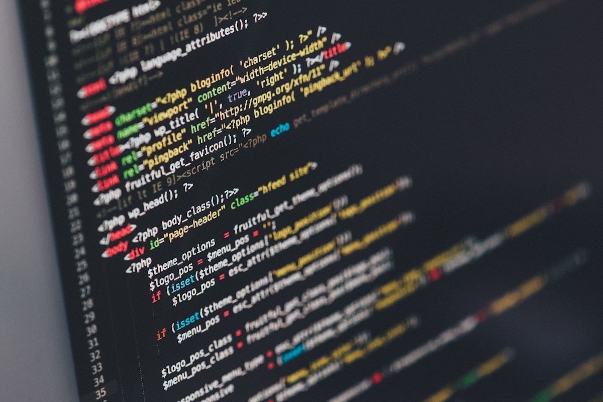 Developer coding on laptop in dark environment